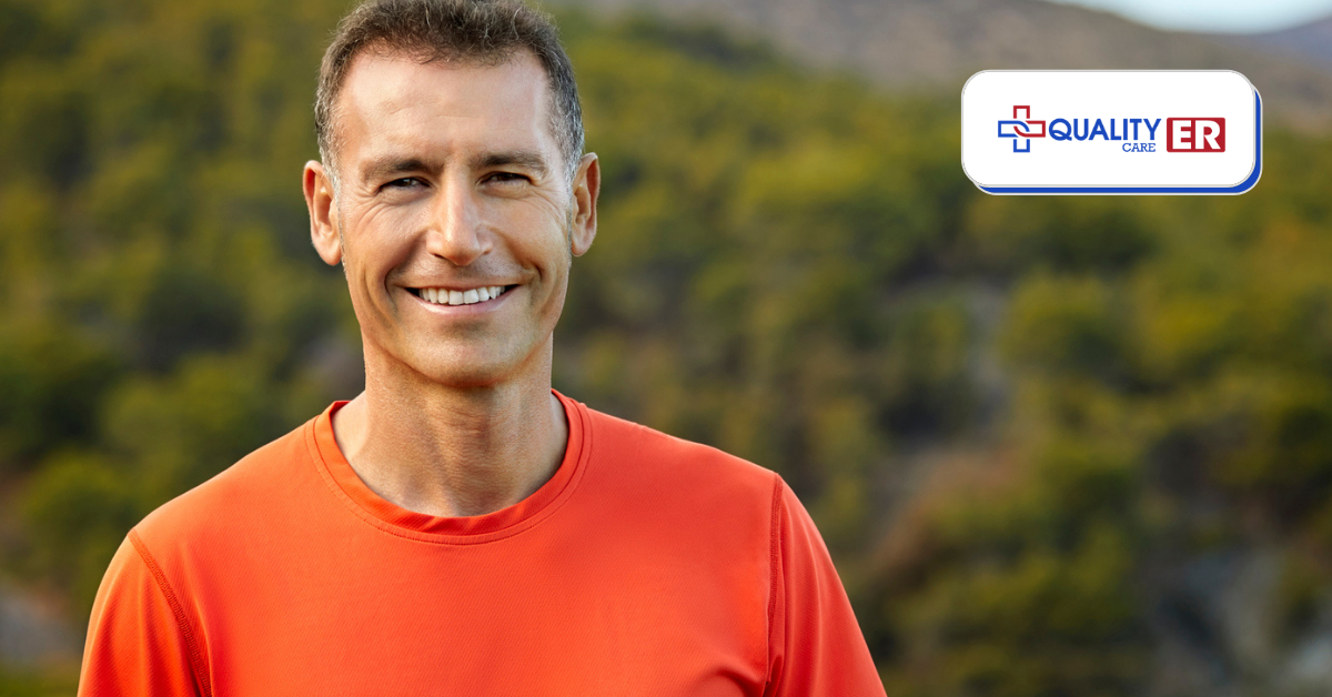 older man in orange shirt smiling outdoors